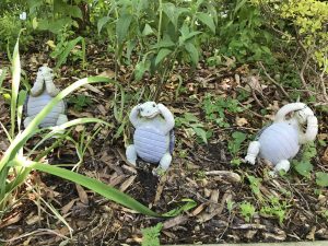 Three ceramic turtles in the grass